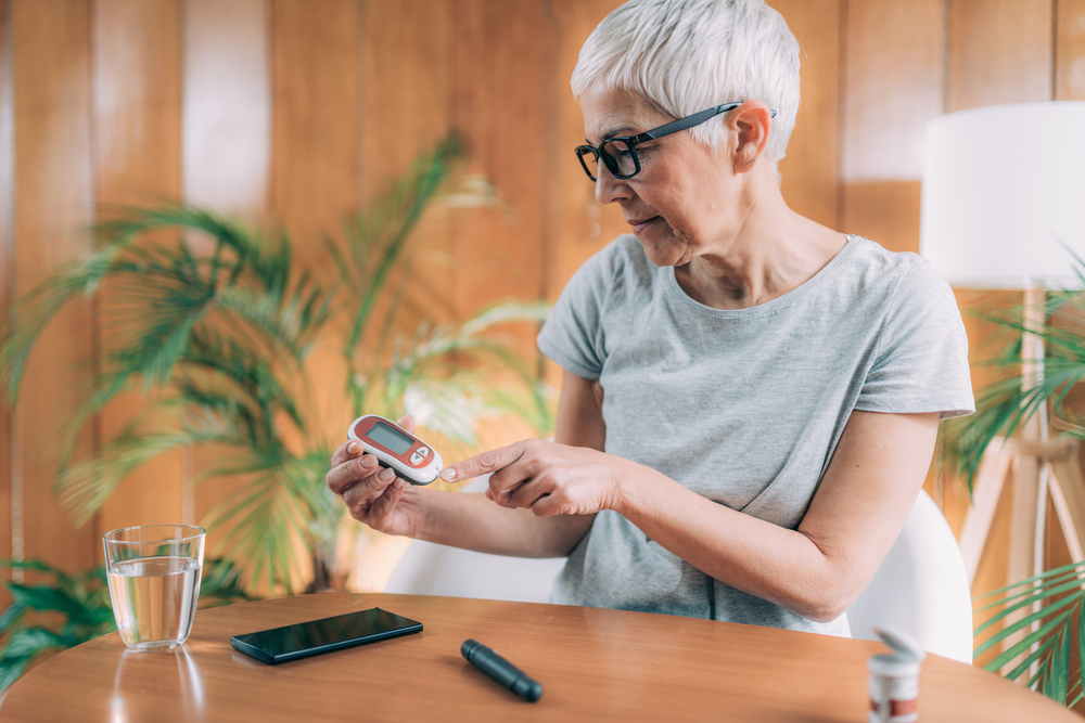 A senior woman measuring her glucose level